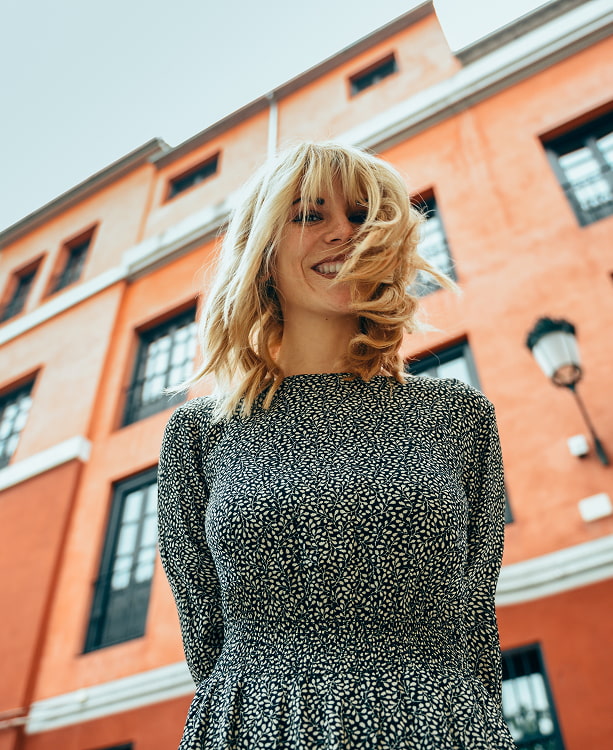 In the heart of the city Woman smiling with city buildings in the background